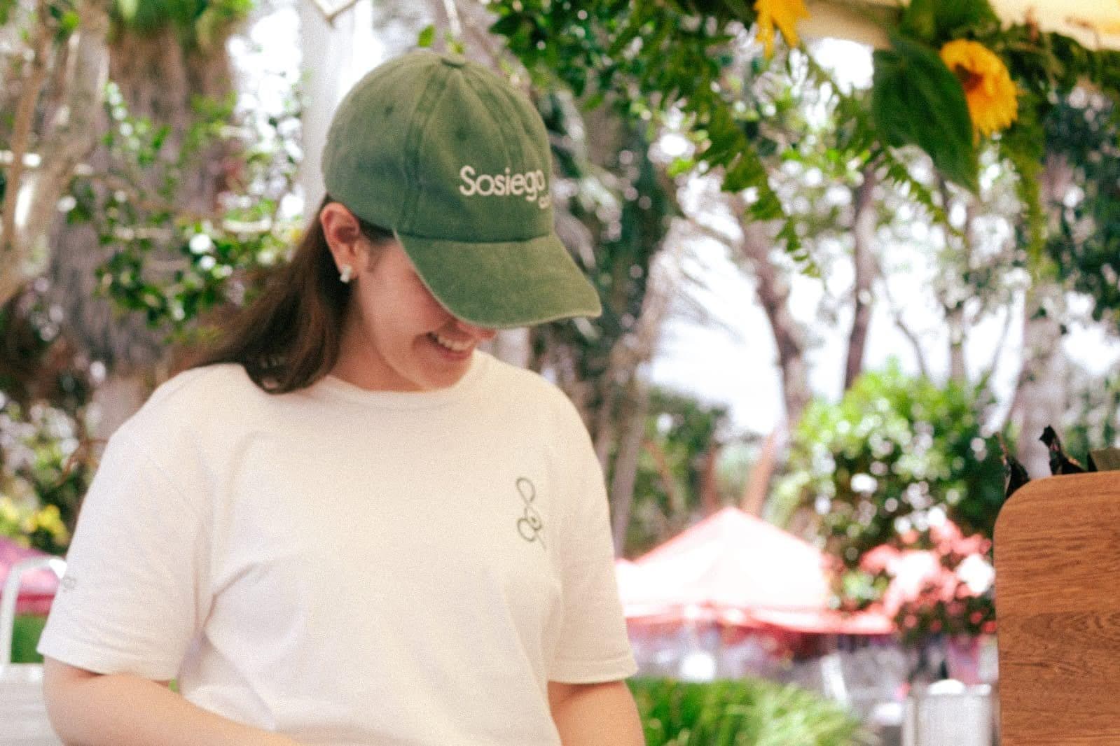 A member of the Sosiego team serves customers at an outdoor fair