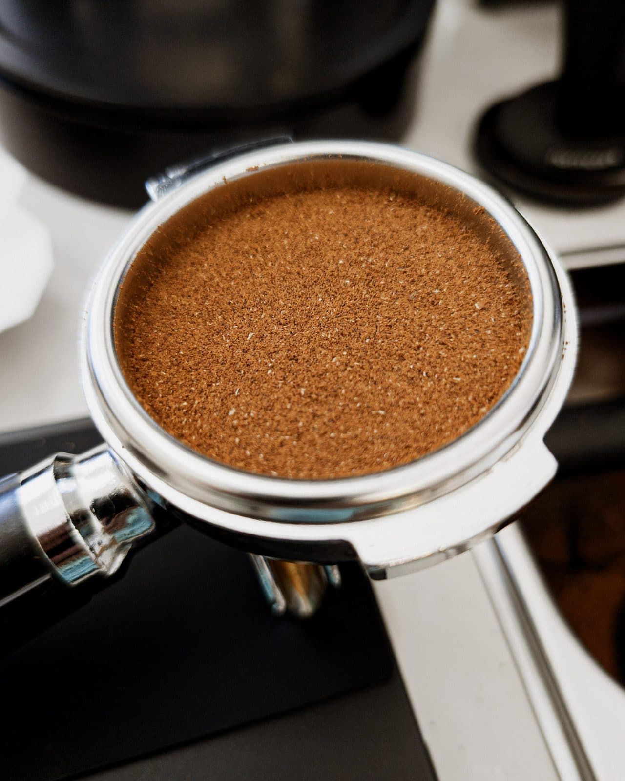 Ground coffee leveled in the portafilter