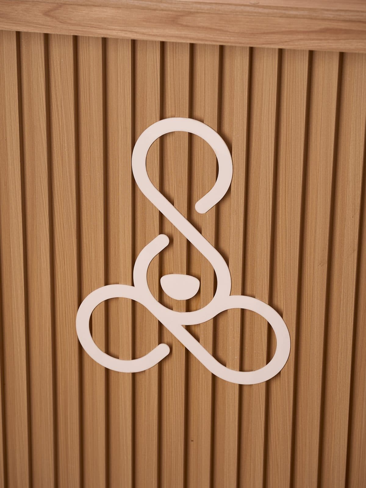 The Sosiego symbol in white on the wooden slats of the counter